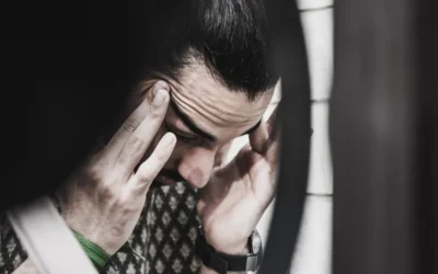 man holding his temples and looking down