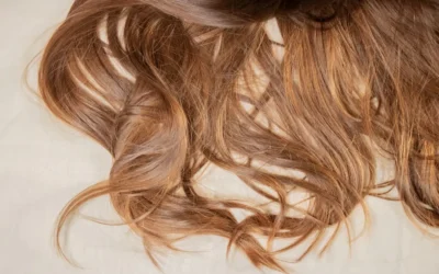 a close up of a woman's hair laying on a bed