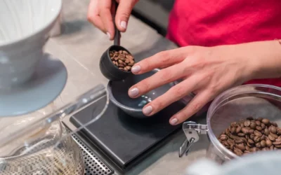 person scooping and measuring coffee beans